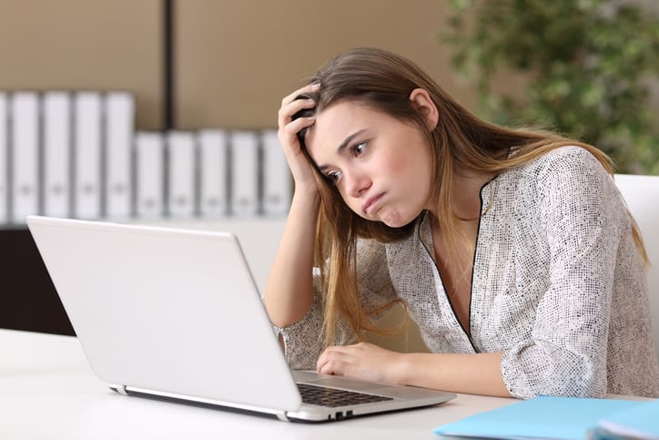 frustrated woman looking at laptop