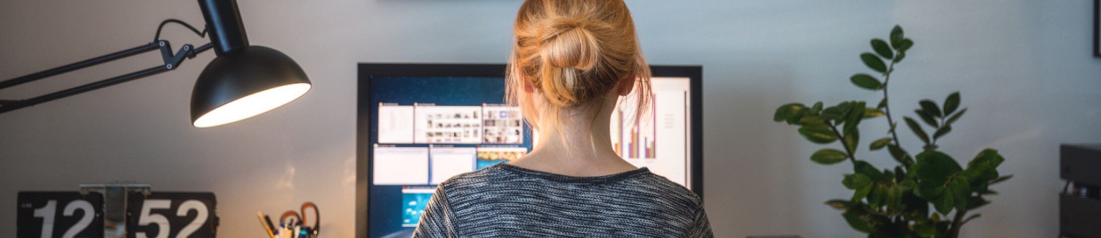 Woman working on computer in her home office during pandemic quarantine.