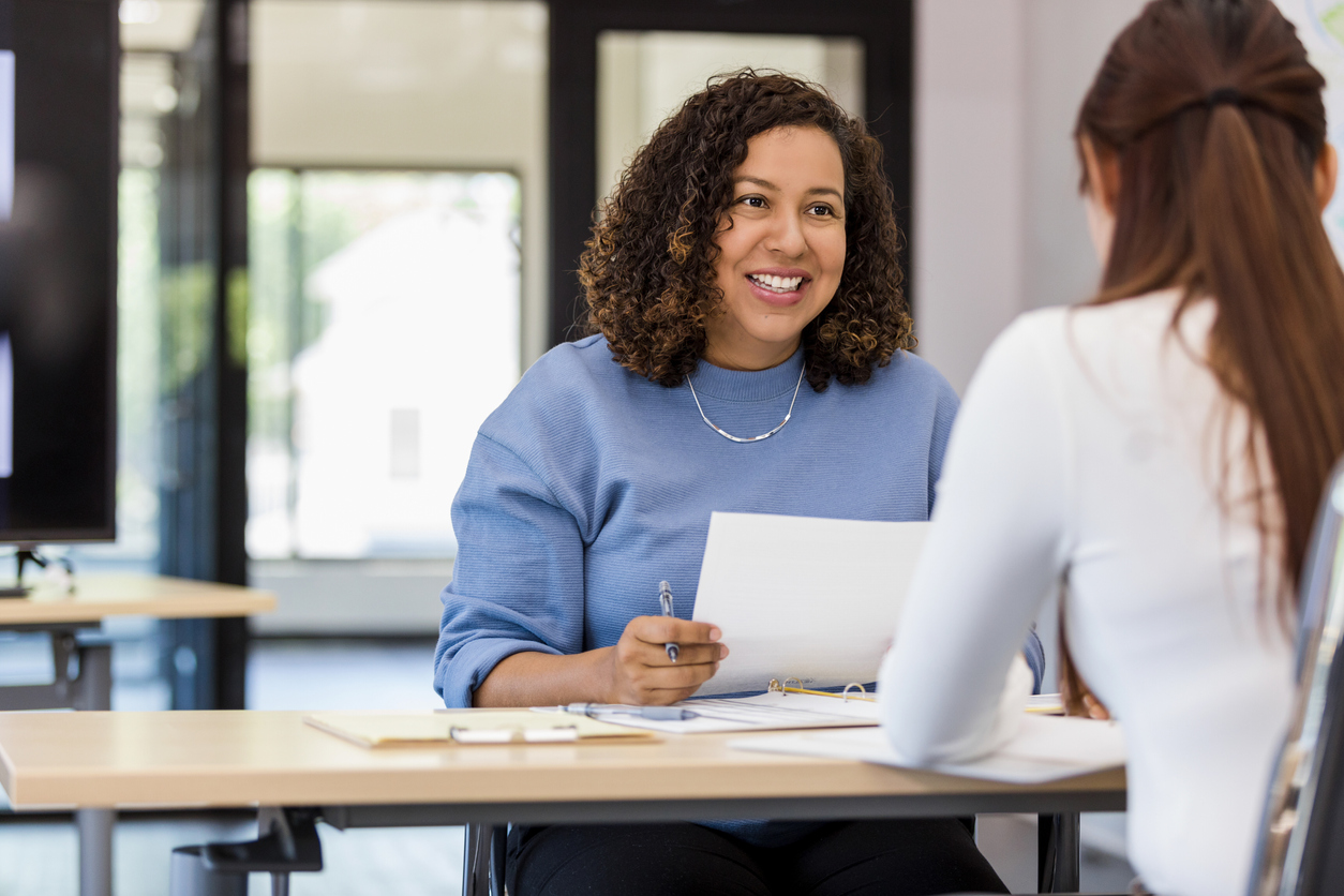 examples of problem solving skills at work Women in blue jumper interviewing women in a white shirt whilst holding a pen and paper