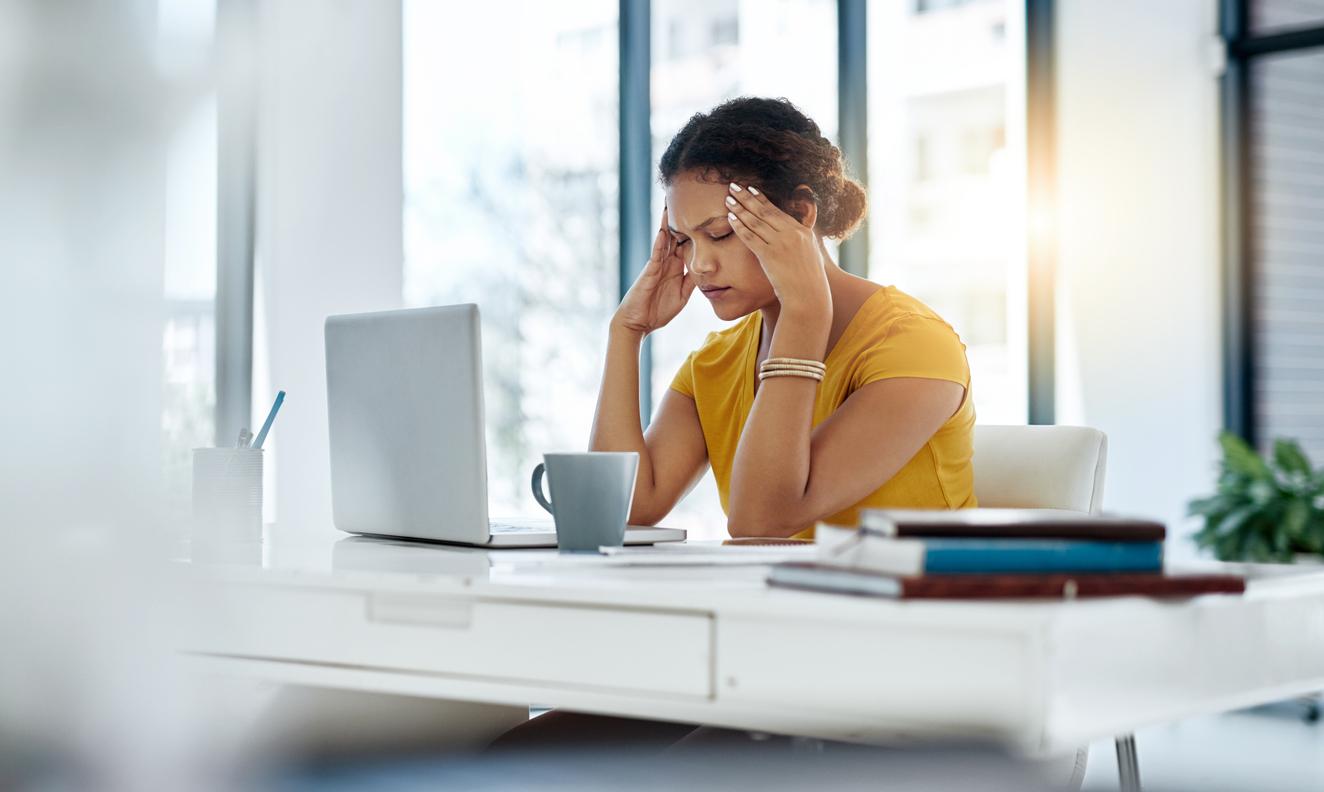examples of problem solving skills at work Women in yellow top with hands on her head whilst looking at a laptop