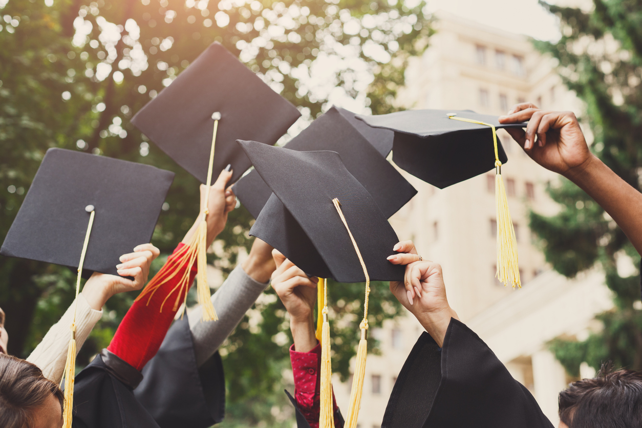 examples of problem solving skills at work Students lifting up their graduation hats into the air
